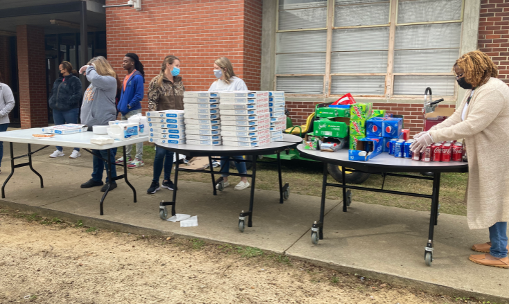The Counseling Dept. passes out pizza and soda to Roll Out participants